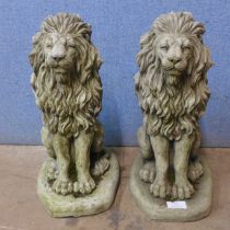 A pair of concrete garden figures of seated lions