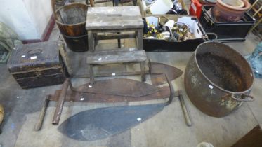 A cast iron cauldron, a tin trunk, tools, etc.
