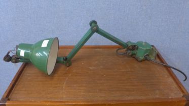 An industrial green metal anglepoise lamp