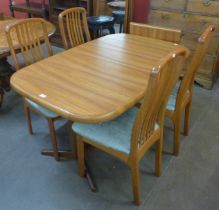 A Danish Ansagar Mobler teak extending dining table and four chairs