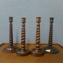 A pair of oak bobbin turned candlesticks, labelled; Made from timber taken from HMS Britannia and