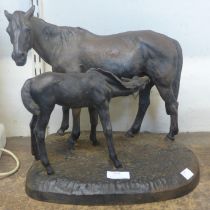 A cast iron figure of a horse and foal