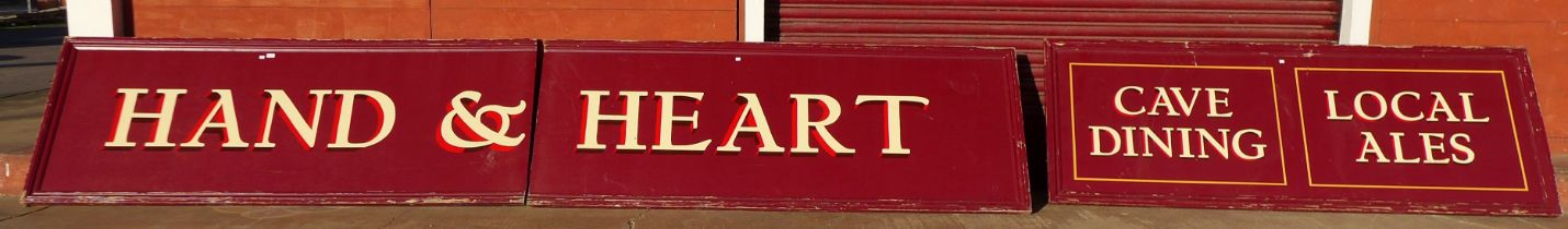 Two large painted pub signs, Hand and Hart and Cave Dining, Local Ales