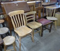 An Ercol Blonde elm and beech chair, two elm seated kitchen chairs, three oak chairs and a bureau