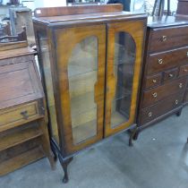 A walnut two door display cabinet