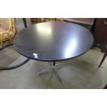 An Eames style aluminium and black lacquered circular dining table