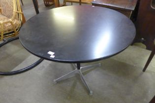 An Eames style aluminium and black lacquered circular dining table