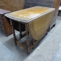 An early 20th Century carved oak gateleg table