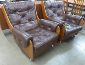 A pair of G-Plan teak and burgundy leather Saddle armchairs. Please note this lot is being sold as a