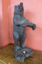 A Black Forest composite faux wood bear stick stand