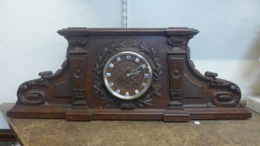 A 19th Century French carved architectural cased oak mantel clock