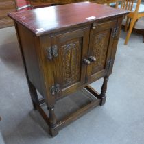 A small carved oak two door cupboard