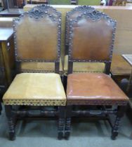 A set of four carved oak and leather upholstered dining chairs