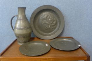 A large pewter ewer and three plates
