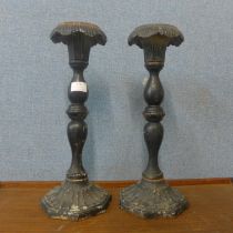 A pair of cast iron ecclesiastical candlesticks
