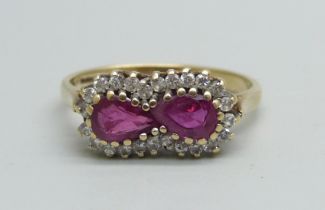 A 9ct gold ring set with two rubies and an outer row of diamonds, 2.3g, N