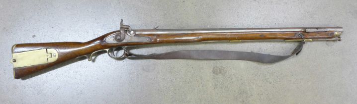 An early 19th Century British Infantry percussion rifle with brass patch box, brass butt plate, stee