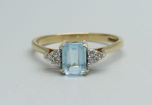 A 9ct gold ring set with a blue topaz and white stones, 2.4g, T