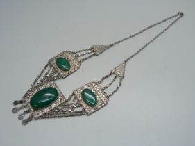 A green stone set Eastern necklace, approximately 43cm