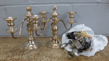 Two plated candelabra and a collection of plated cutlery **PLEASE NOTE THIS LOT IS NOT ELIGIBLE