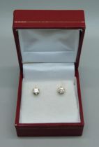 A pair of 18ct gold and diamond stud earrings, total 0.60 carats, 1.3g