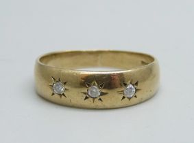 A 9ct gold ring set with three diamonds, 2.7g, R