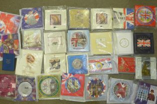 Twenty-eight coin sets, dating from 1986-2006, including a Trafalgar commemorative crown, Coronation