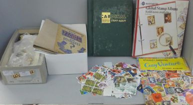 A large quantity of loose stamps and a quantity of stamp albums