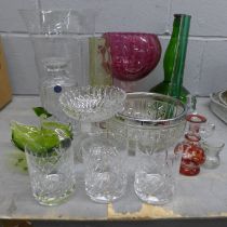 A collection of glassware including colourd glass and two eye baths, a cut crystal decanter with