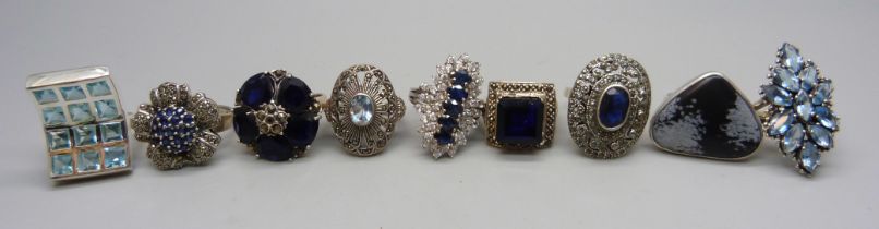 Nine chunky large silver rings set with blue and black stones, obsidian, spinel, etc., up to 35mm,