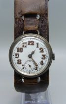 A silver cased trench watch on a leather strap