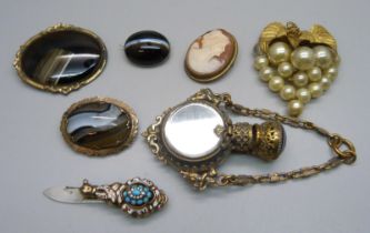 A collection of brooches, a scent bottle (lid a/f), and a clip