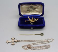 A gold plated cross pendant on a yellow metal chain, a yellow metal and seed pearl bird brooch,