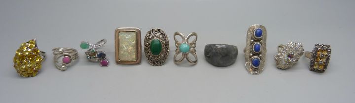 Ten chunky large silver rings set with citrine, turquoise, malachite, emerald, sapphire, ruby, etc.,