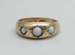 A 9ct gold ring set with three opals, 1.4g, M, some dents to shank