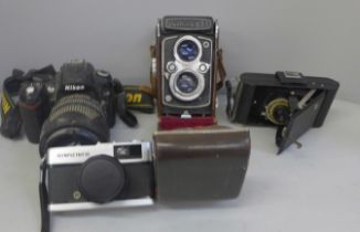 A collection of cameras, including Yashica and Nikon