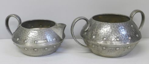 A Homeland hammered pewter cream and sugar