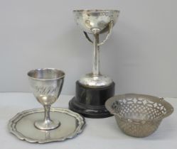 A pierced basket, no handle, a silver plated trophy and egg cup and tray