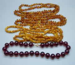 A collection of four amber and amber style necklaces