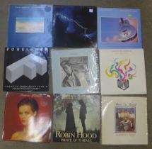 A collection of 1980s pop and rock LP records, including Dire Straits, Foreigner, Sade, etc.