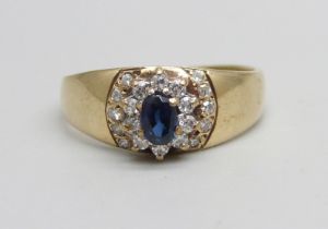 A 9ct gold, diamond and sapphire ring set with 20 diamonds and a central sapphire, 1.7g, M