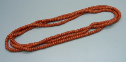 A coral long guard chain, approximately 144cm