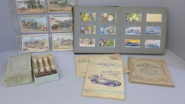 A collection of cigarette cards, three albums