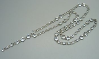 An antique white metal paste set riviere necklace, extra long length, unmarked but tests as