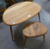 An Ercol elm and beech pebble shaped nest of two tables