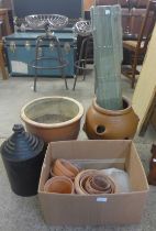 A terracotta strawberry planter, terracotta plant pots, oil can, etc.