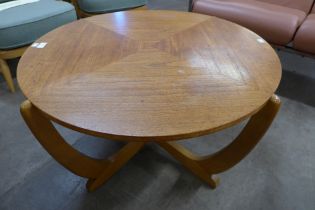 A teak circular sunburst coffee table