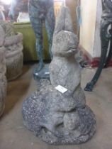 A concrete garden figure of rabbits