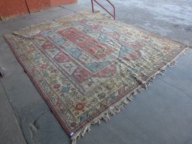 A large Turkish terracotta ground rug, 380 x 290cms