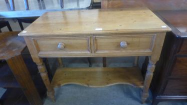 A Victorian style pine two drawer kitchen serving table